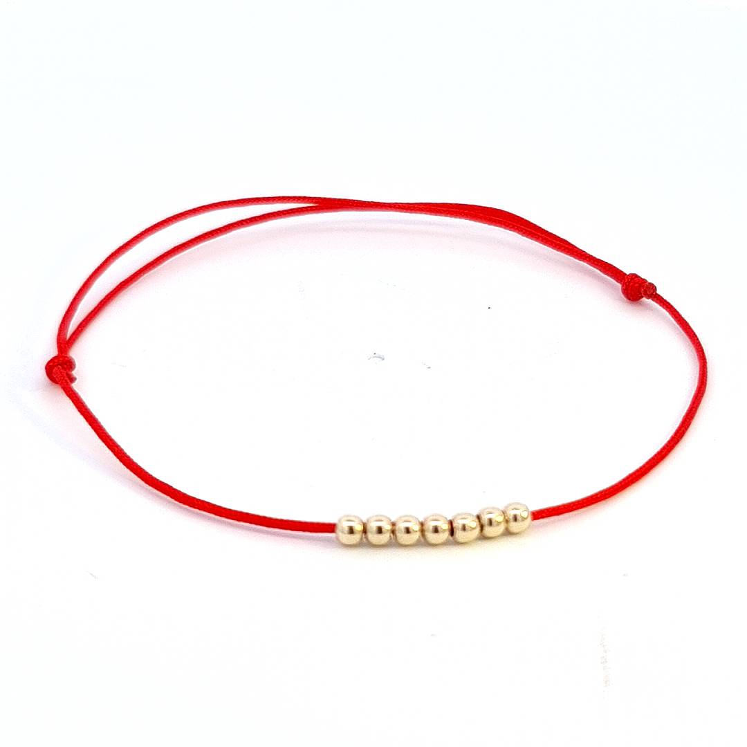 14k Solid Gold Bead Bracelet with seven gold beads on a red macramé cord, representing the Seven Gifts of the Holy Spirit, designed for Confirmation