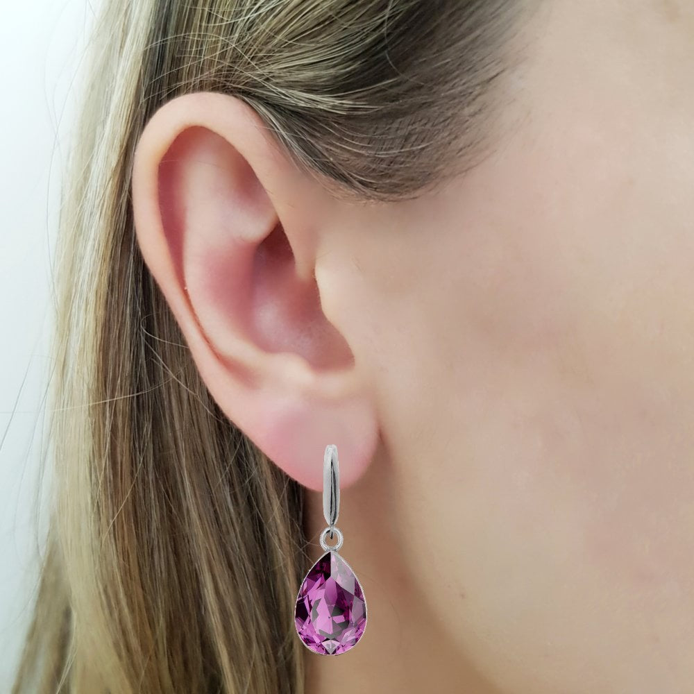 Woman wearing a Dangling Pear-Cut Drop Earrings in Sterling Silver with Amethyst Purple Teardrop Austrian Crystals