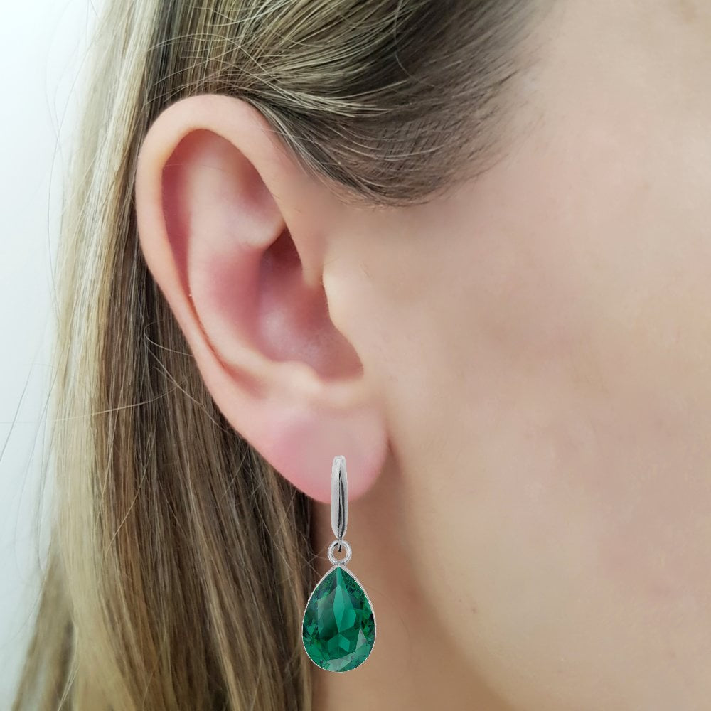 Woman wearing a Dangling Pear-Cut Drop Earrings in Sterling Silver with Emerald Green Teardrop Austrian Crystals