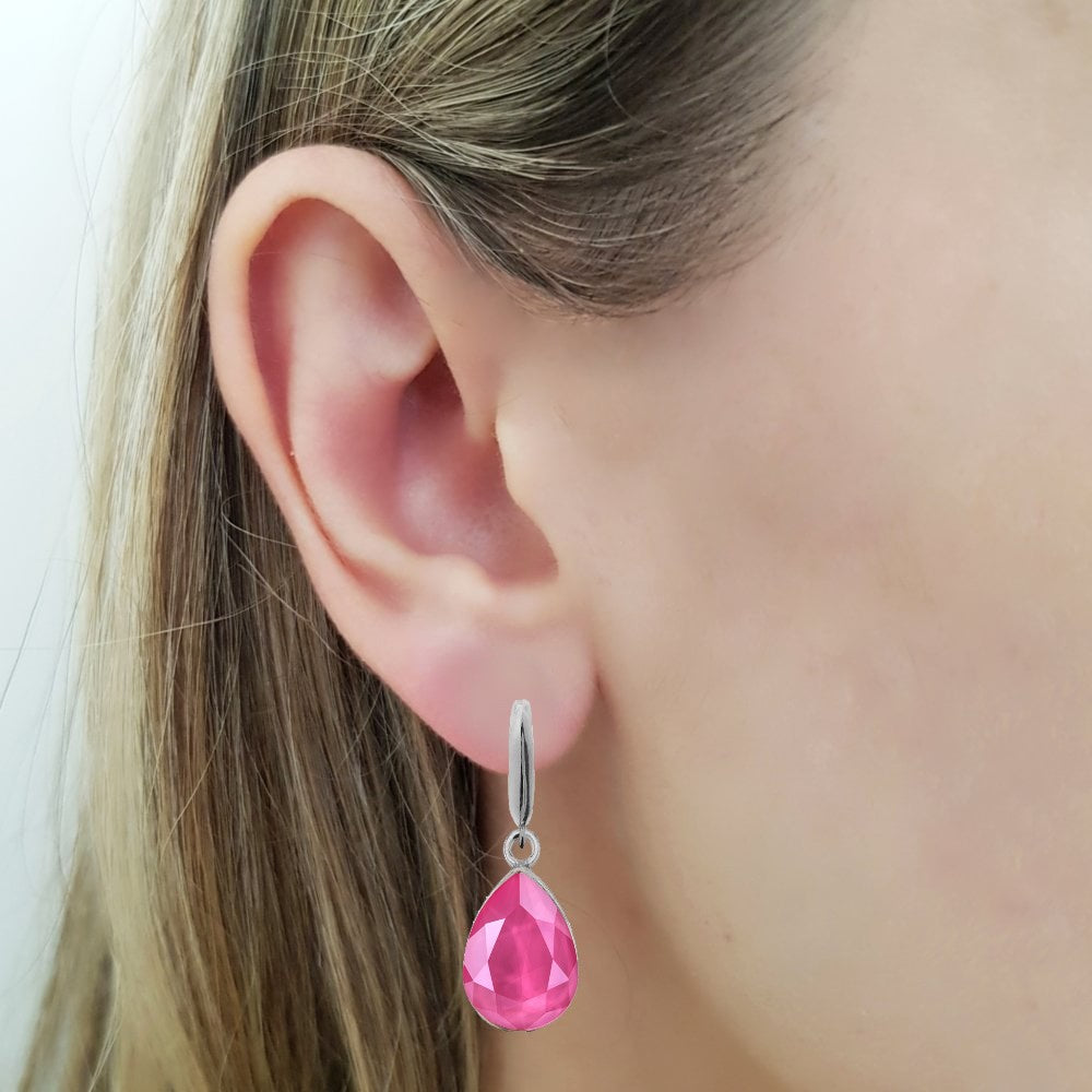 Woman wearing a Dangling Pear-Cut Drop Earrings in Sterling Silver with Peony Pink Teardrop Austrian Crystals