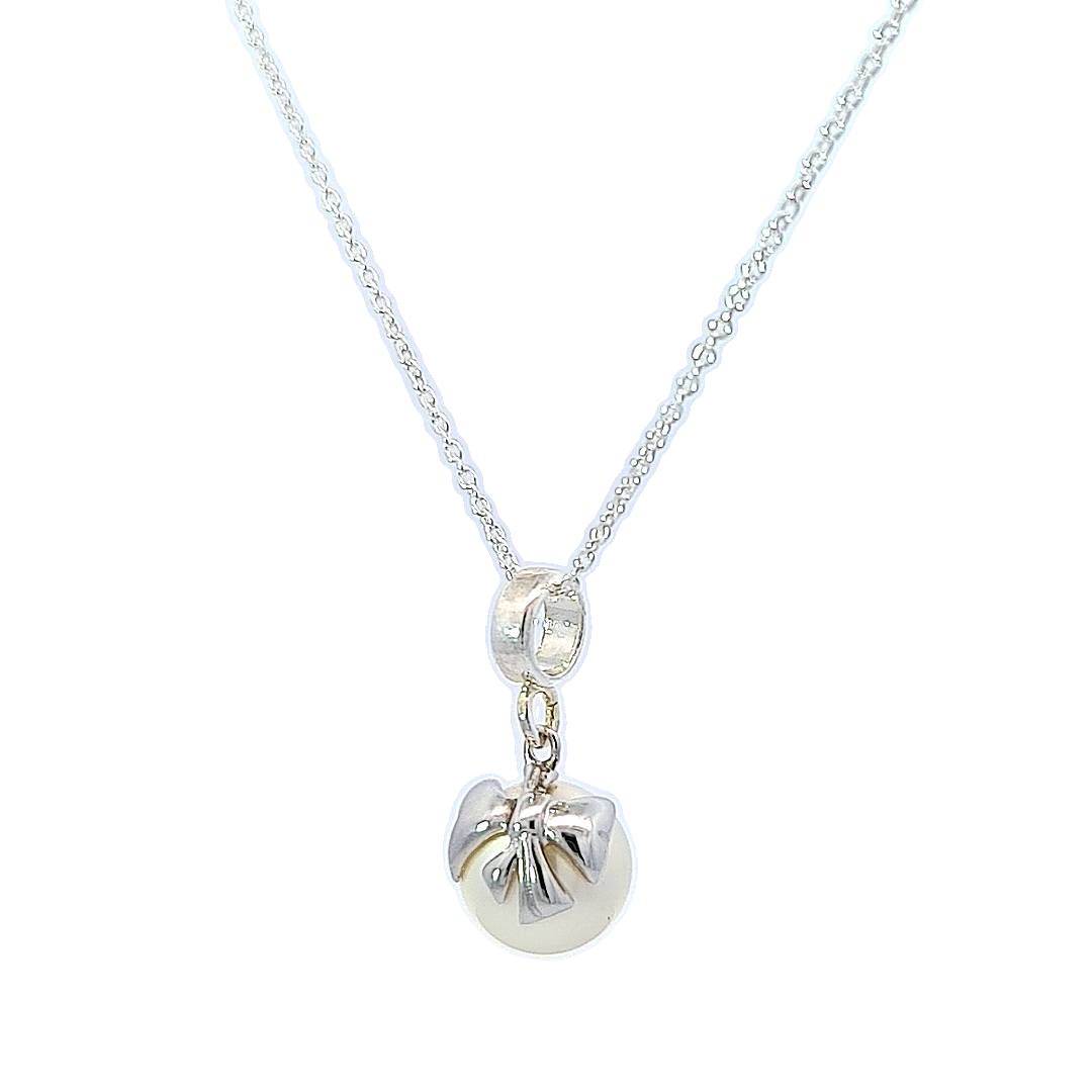 Close-up of Bow Embraced Pearl Drop Necklace in Sterling Silver by Magpie Gems in Ireland