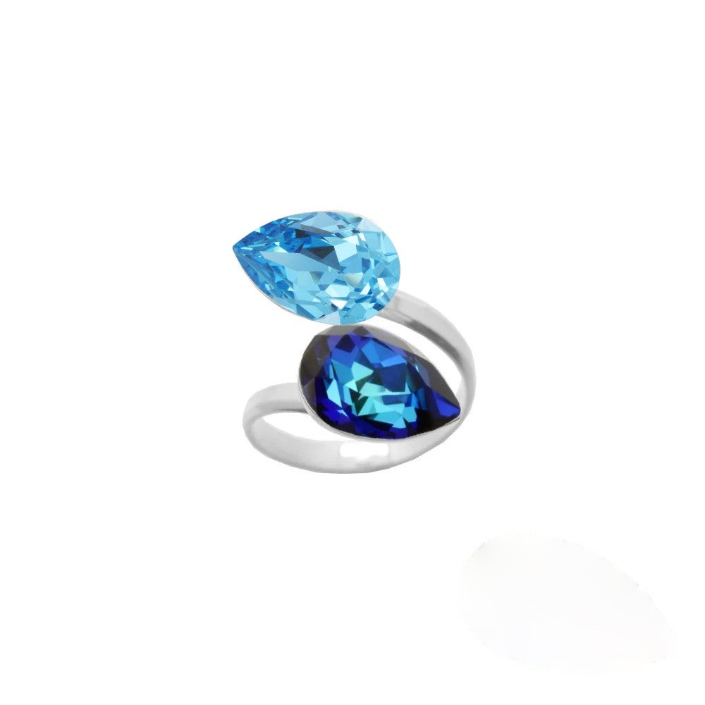 Elegant dual crystal ring for women, crafted from 925 Sterling silver with Aquamarine and Bermuda Blue pear-cut crystals, wrapped delicately around the finger, handmade by Magpie Gems in Ireland.
