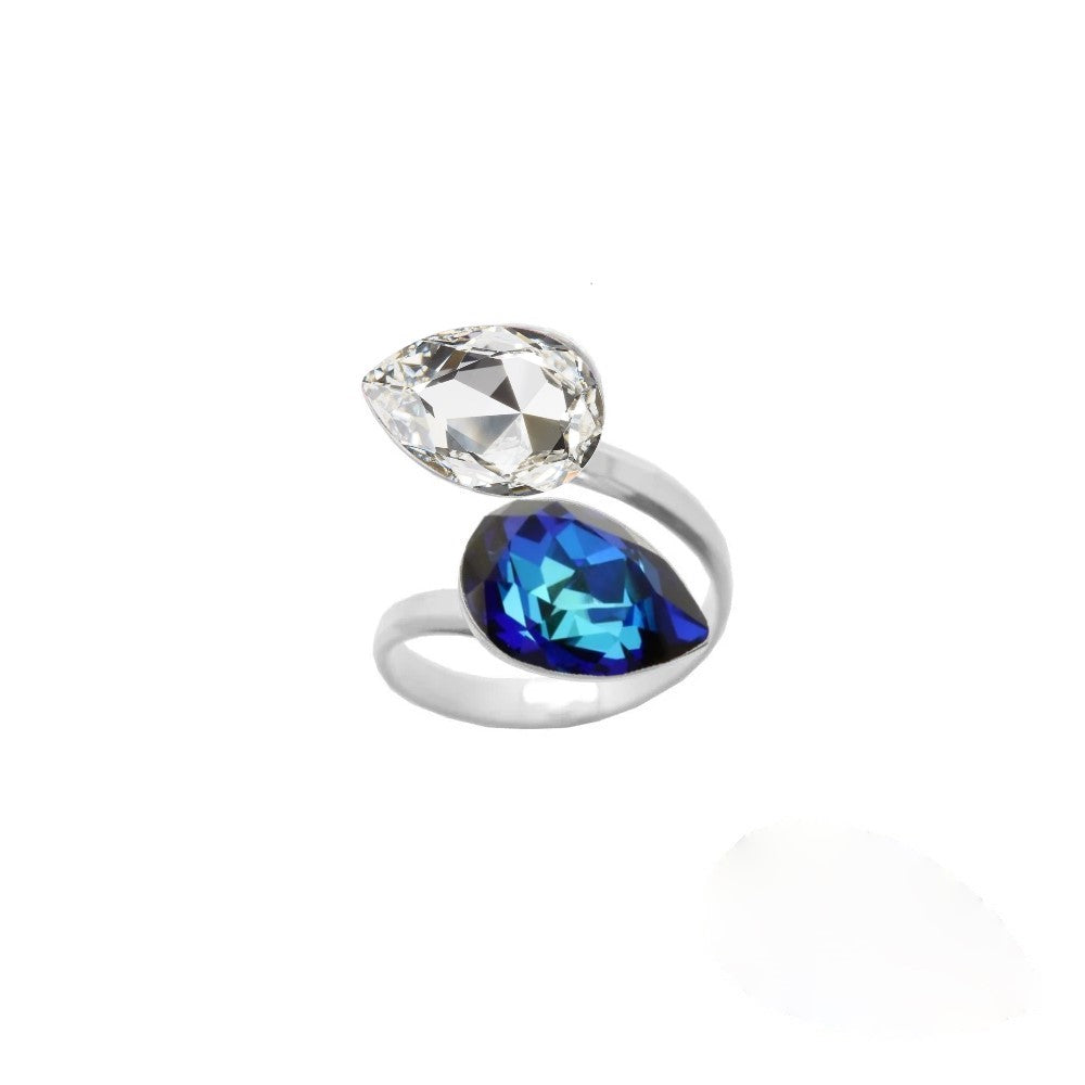 Women's dual crystal ring with a unique wrap-around design, made from 925 Sterling silver and showcasing Bermuda Blue and Clear pear-cut crystals, created by Magpie Gems in Ireland.