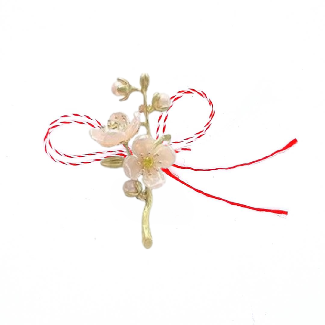 Ivory Jasmine Martisor Brooch on a white background, featuring soft ivory-toned jasmine blossoms with golden accents and a red and white Martisor bow, symbolising spring and grace.