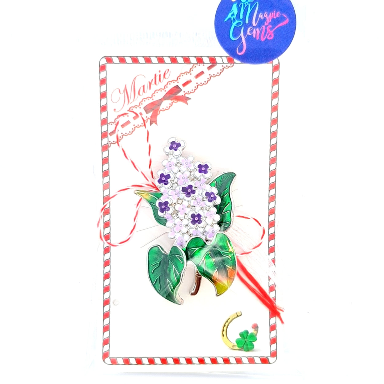 Ready to Gift Lilac Flower Martisor Brooch displayed on a festive card and clear bag with red and white details, showcasing vibrant purple blossoms and green leaves, paired with the traditional red and white Martisor bow, representing the beauty of spring and renewal.