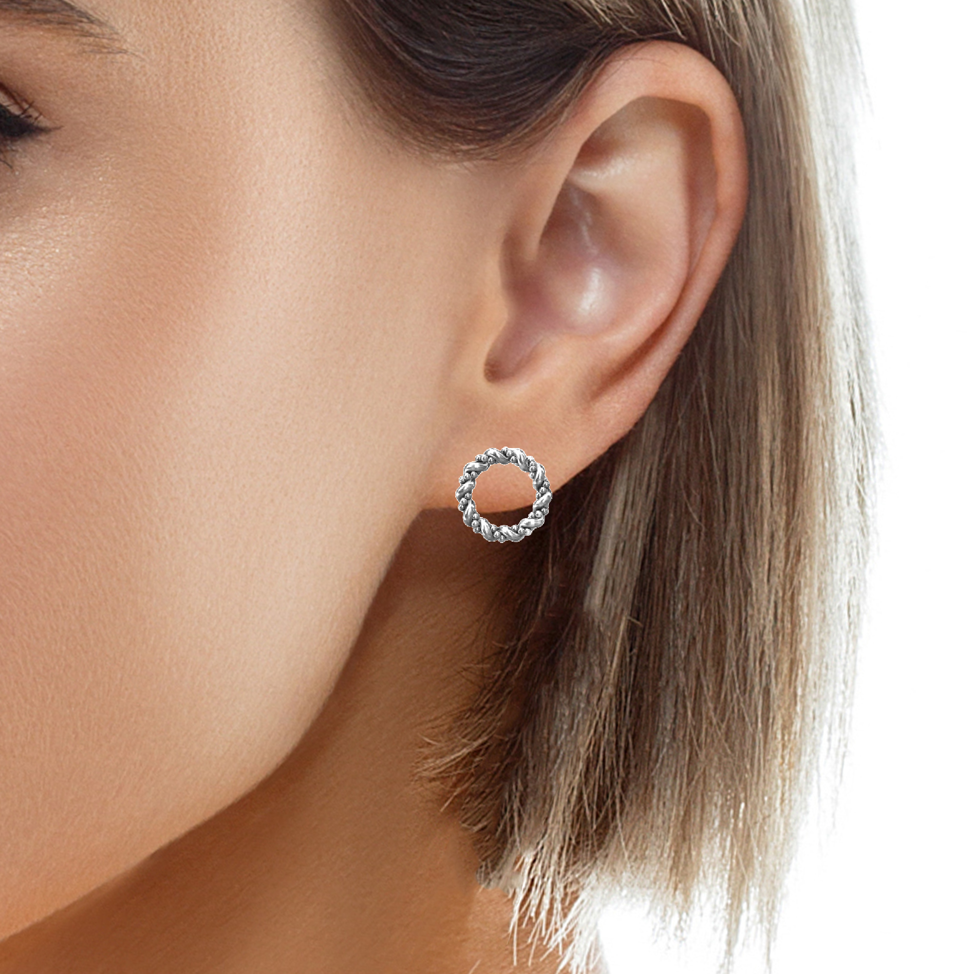 Female model wearing braided hoop stud earrings in sterling silver by Magpie Gems in Ireland.