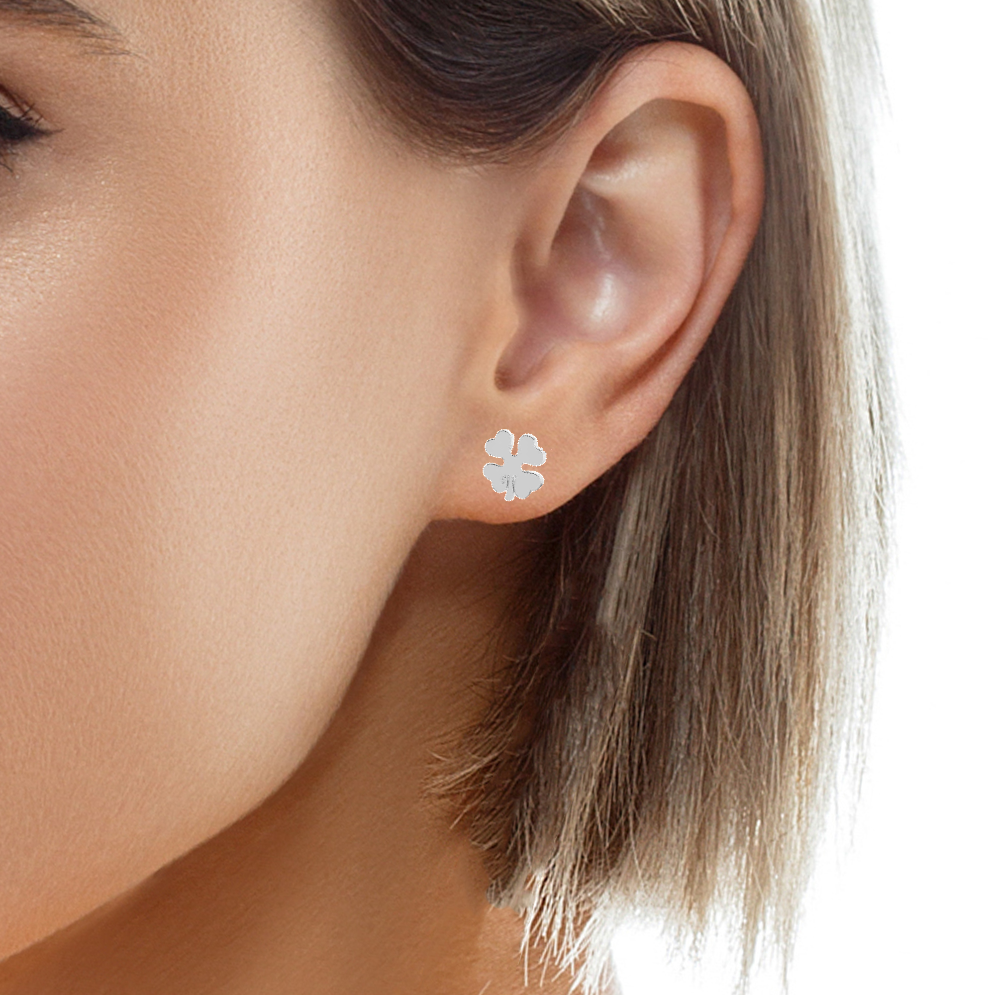 Four-Leaf Clover Silver Stud Earrings worn by a model, showing the delicate and sophisticated look.