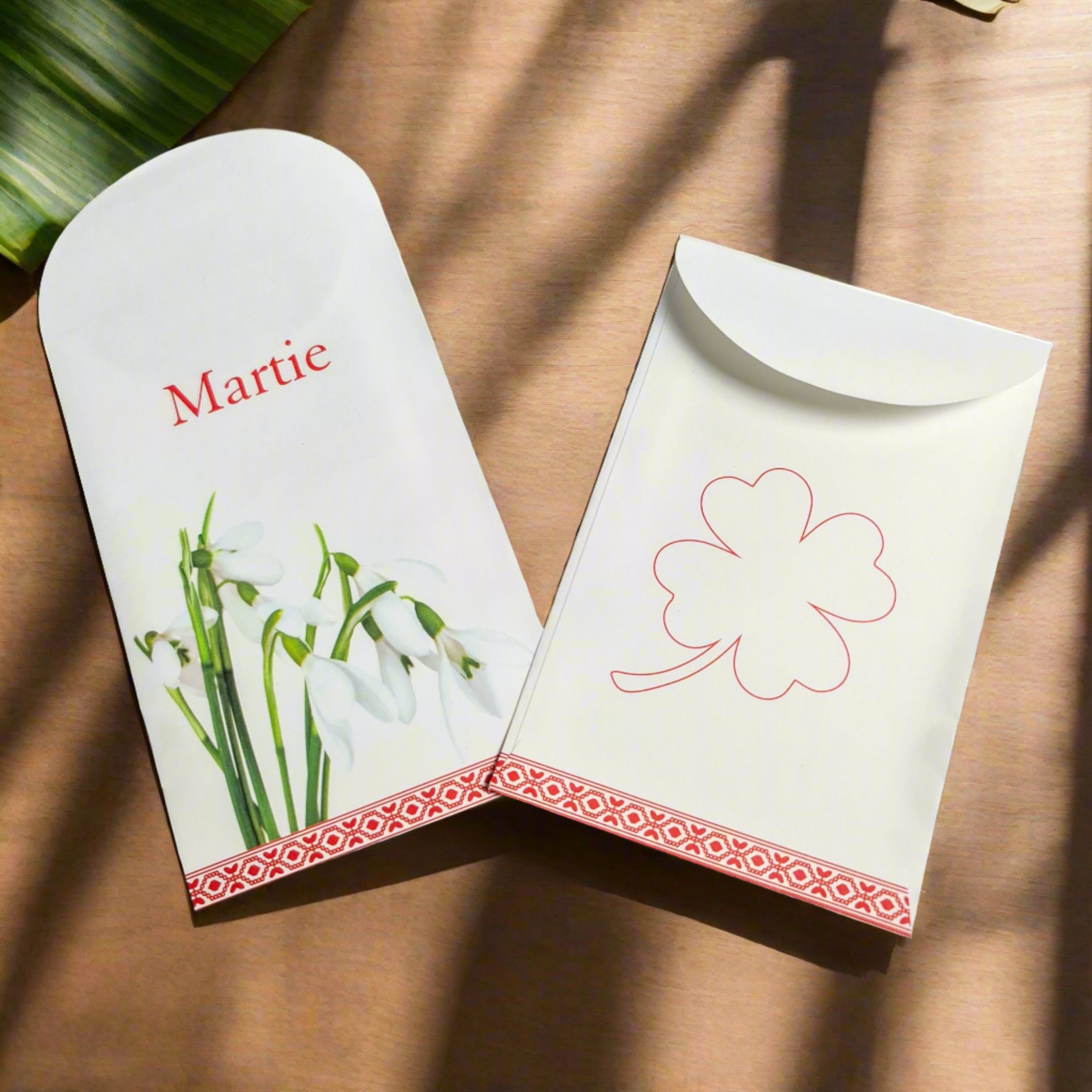 Elegant paper gift bags featuring snowdrop and clover designs, perfect for Martisoare presentation and spring gifting.