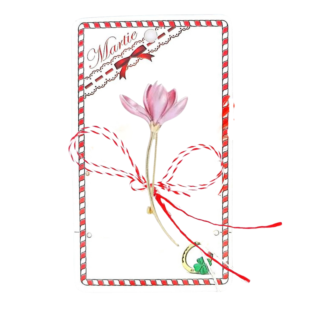 Pink Crocus Martisor Brooch displayed on a decorative card with traditional red and white accents, featuring delicate pink petals and a golden stem, complemented by the iconic red and white Martisor bow, symbolising spring and renewal.