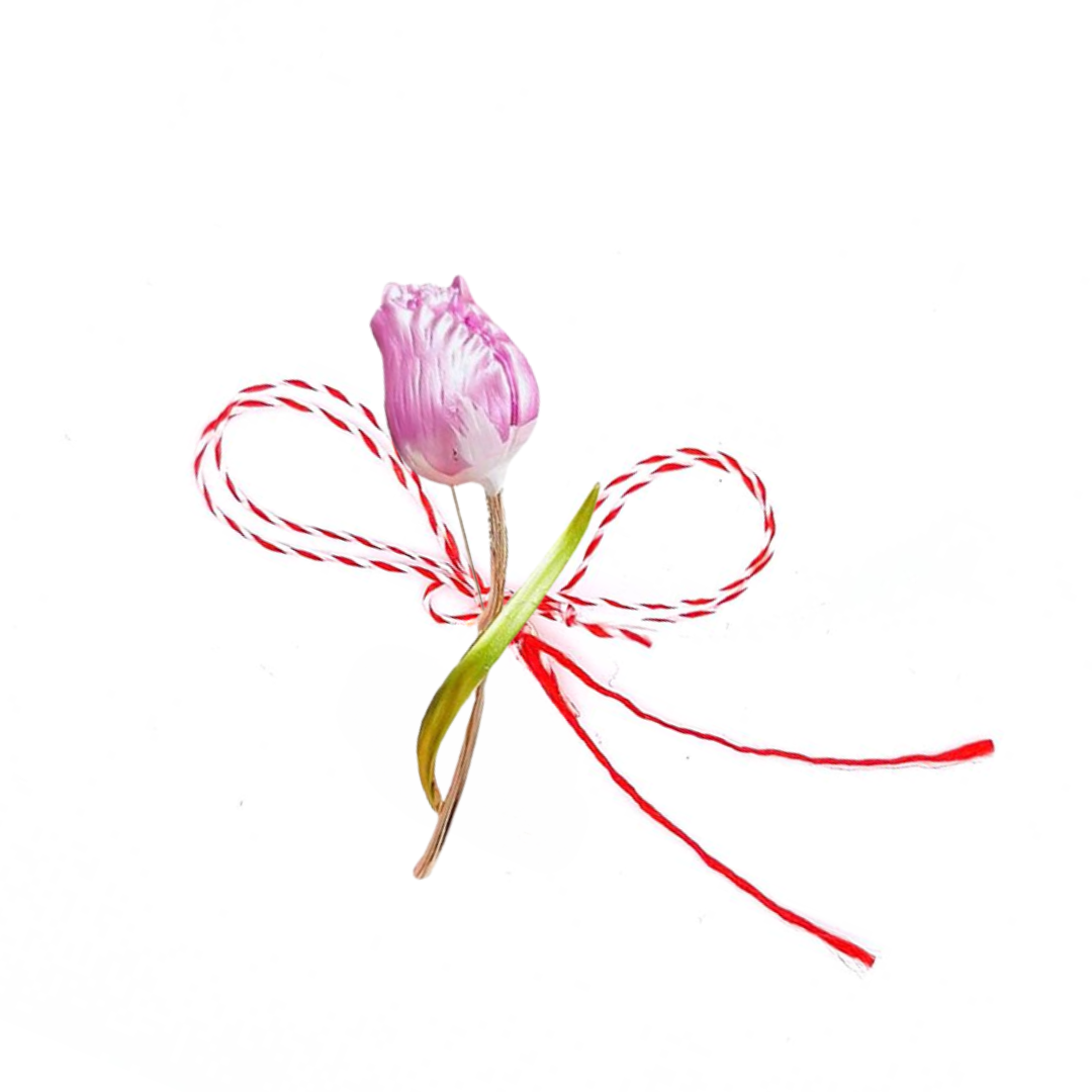 Pink Tulip Martisor Brooch on a white background, featuring a delicate pink enamelled tulip with golden accents, symbolising spring and renewal, paired with a traditional red and white Martisor bow.