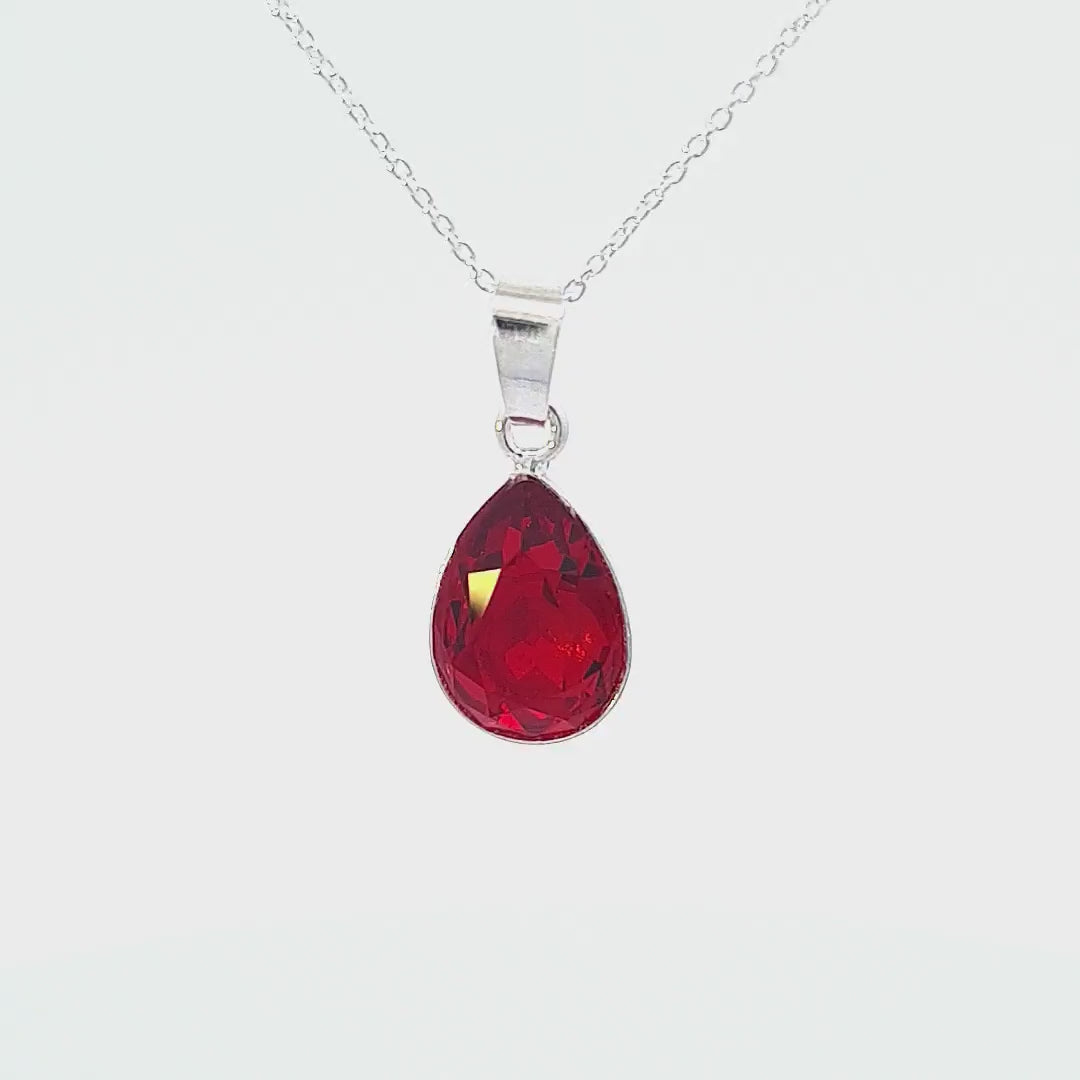 Close-up video displaying the elegant teardrop pendant necklace with a Red Scarlet Ignite Austrian Crystal and Sterling Silver Chain