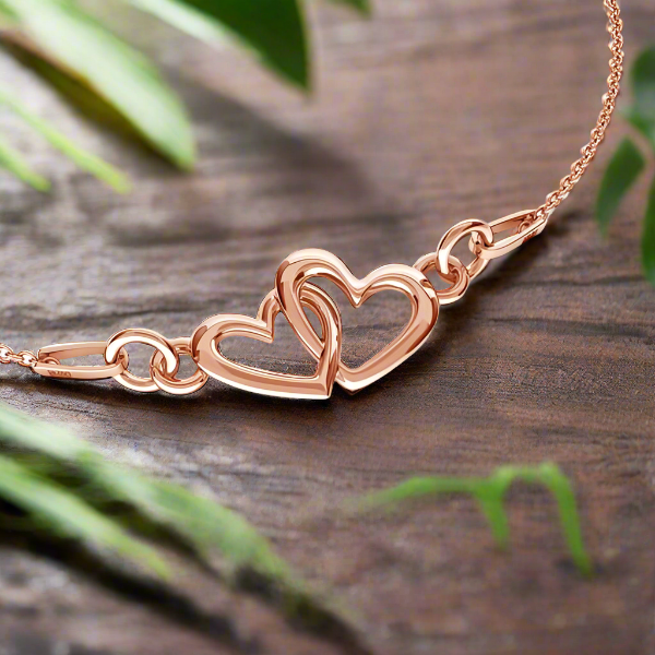 Our hearts as one -&nbsp;Introducing the Rosegold Plated Sterling Silver Necklace with Intertwined Heart Pendant, a stunning piece of jewelry that perfectly captures the essence of love and romance. 