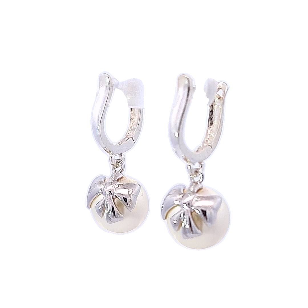 A pair of Sterling Silver Huggie Earrings with a White Pearl Crystal and Silver Bow