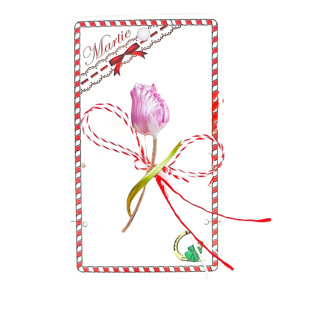 Soft Pink Tulip Martisor Brooch displayed on a decorative card with red and white accents, featuring a delicate pink tulip and green leaves, complemented by the traditional red and white Martisor bow, symbolising spring and renewal.