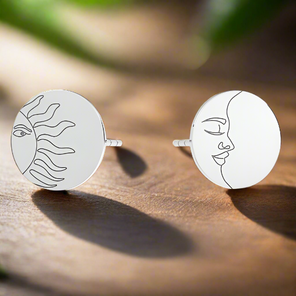 Sterling silver stud earrings featuring celestial Sun and Moon designs, perfect for astrology lovers or as a cosmic-themed gift.