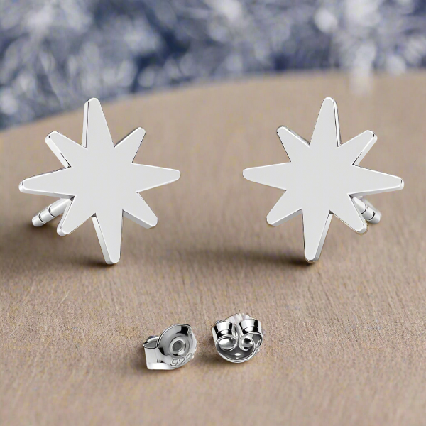 Winter Star Sterling Silver Stud Earrings – artistic display of 8.5mm star design on wooden background