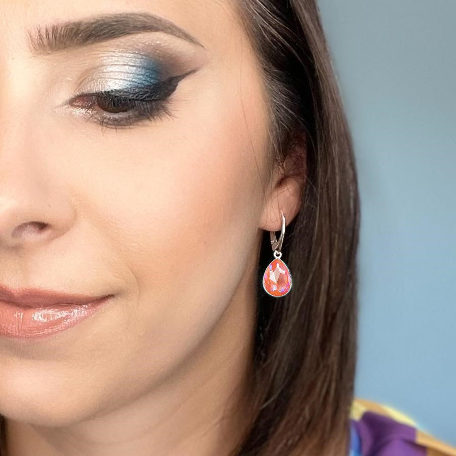 Woman wearing Sterling Silver Teardrop Earrings with Orange Glow DeLite Pear-Cut Crystals from Austria, made by Magpie Gems in Ireland