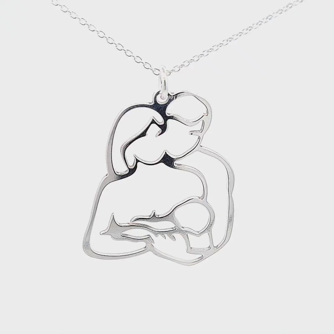 Video showcasing the Unconditional Love Necklace in Sterling Silver, featuring a father hugging the mother of his child, while the mam is holding the baby