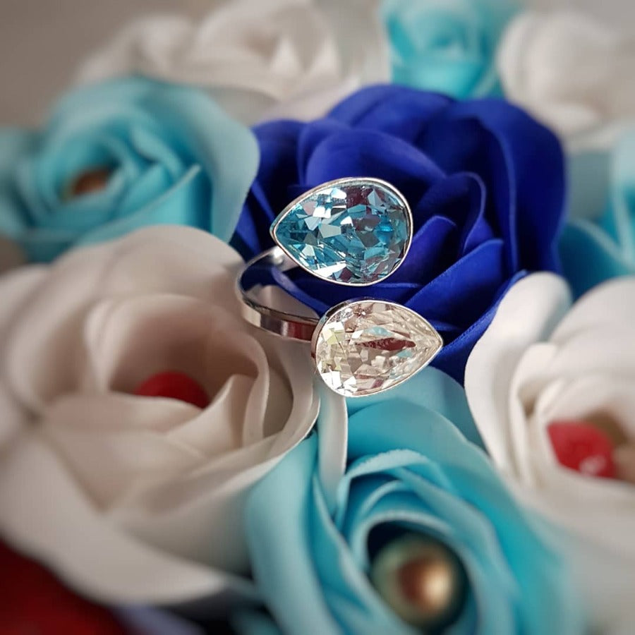 Aquamarine Dream Wrap Around Cocktail Ring in the middle of blue and white roses