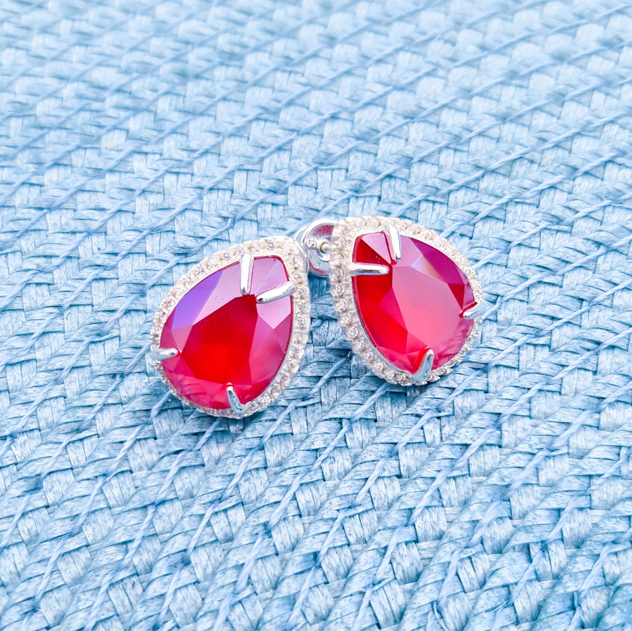 Close-up of Large Royal Red Dazzling Pear Stud Earrings, Statement Stud Earrings