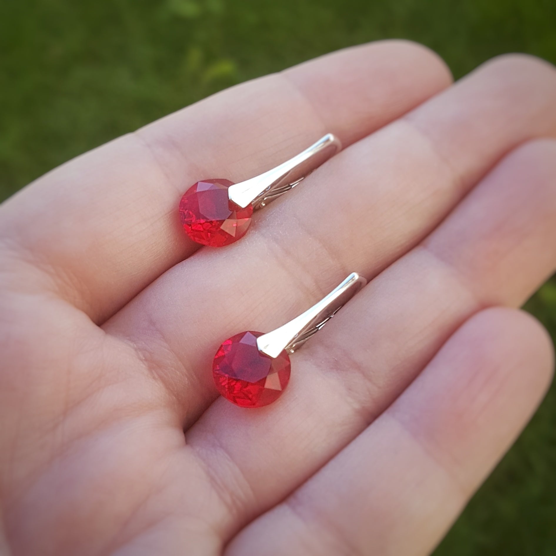 Hand holding Light Siam Red Crystal Leverback Earrings