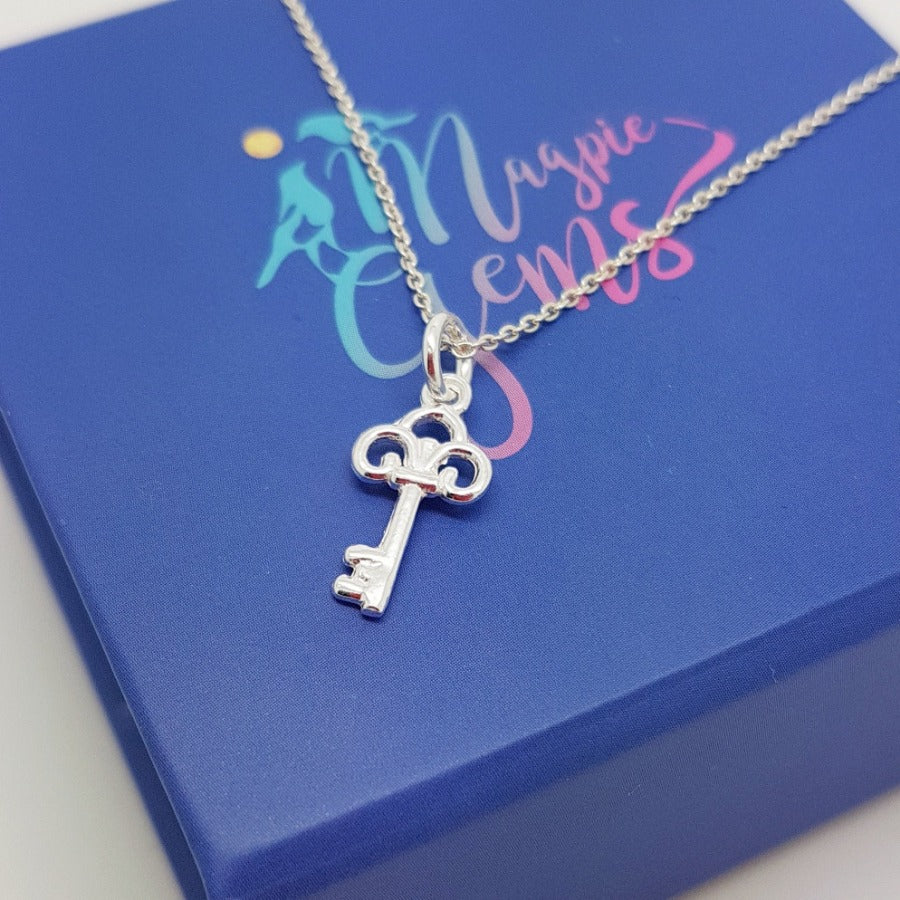 A close-up of a sterling silver key pendant necklace. Ambition & Success Key Necklace - Personalised Sterling Silver Jewellery Ireland. Birthstone necklace. Shop Local Ireland - Ireland