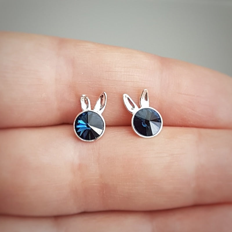 Close-up of Sterling Silver Bunny Stud Earrings showcasing the playful bunny ears design and denim blue crystal.