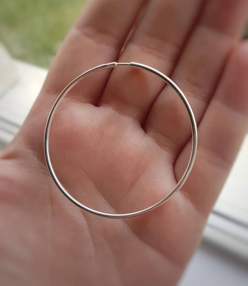 terling Silver Hoop Earrings held in hand, displaying their large 5.5cm size